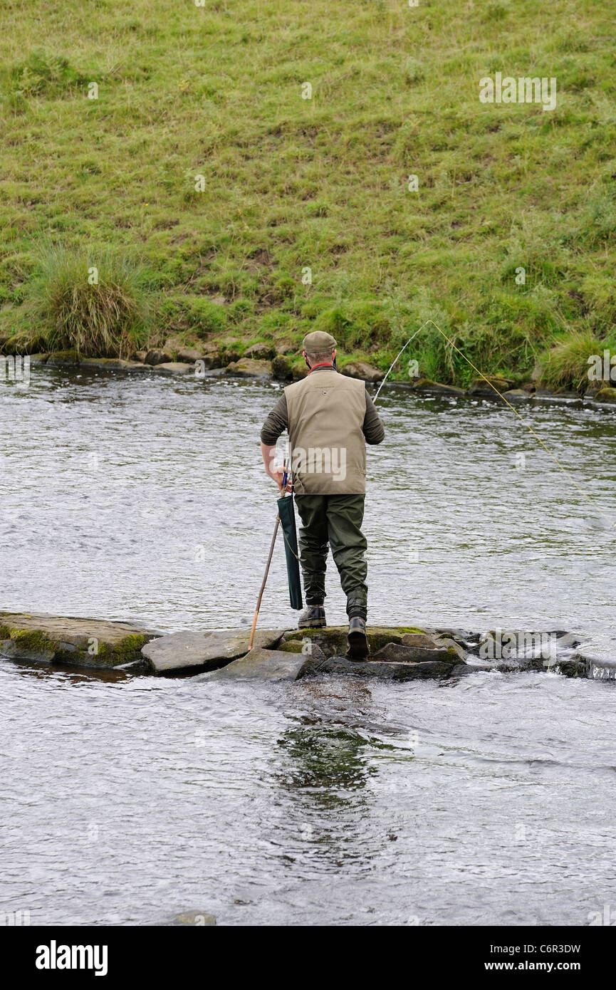 man fly fishing river derwent chatsworth park estate derbyshire england