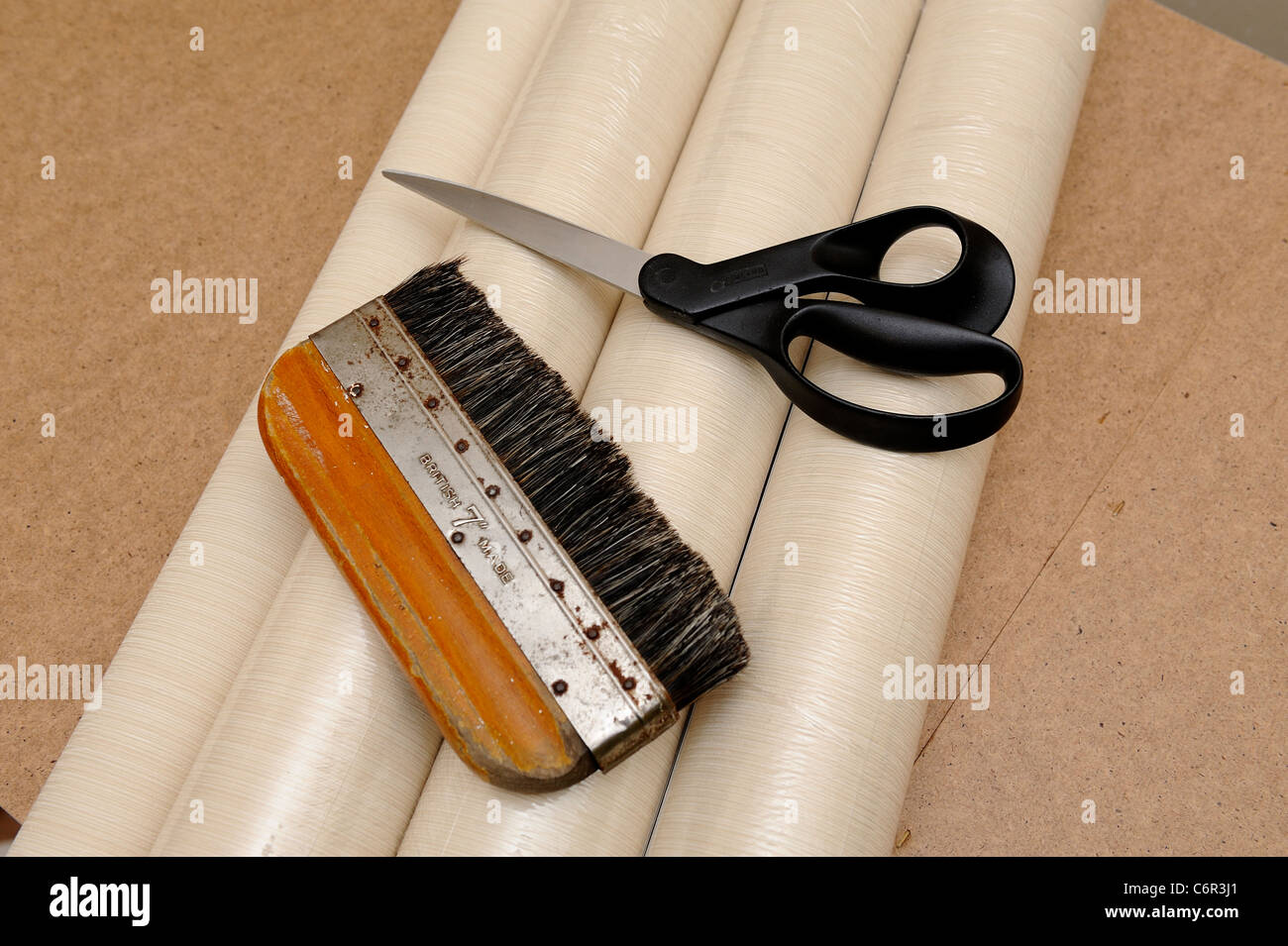 wallpaper scissors and smoothing brush england uk Stock Photo