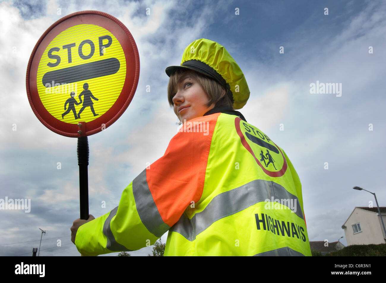 Pretty smiling teenage lollipop lady on school crossing patrol duty in rural Cornwall Stock Photo