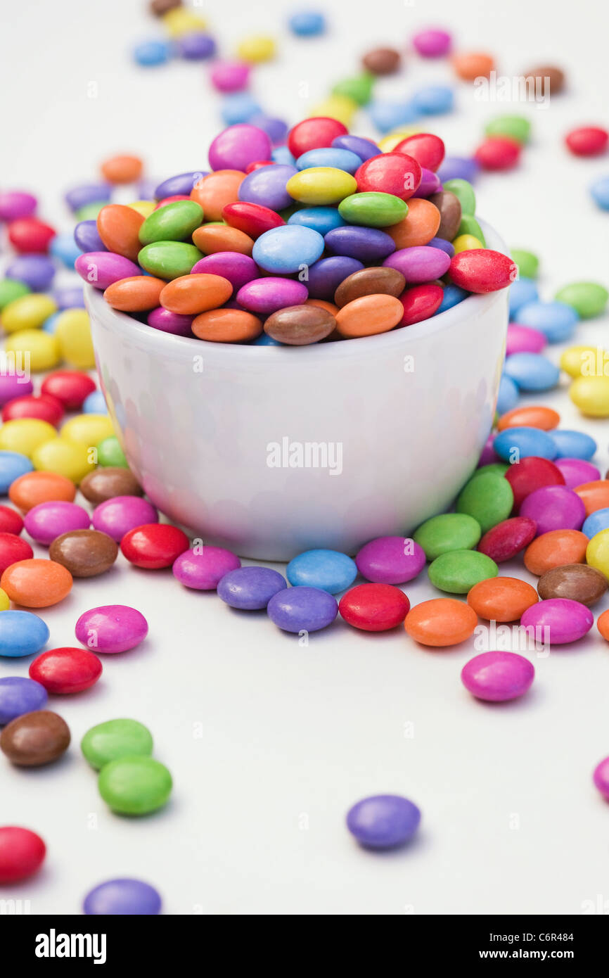 Smarties in a white bowl on a white background. Stock Photo