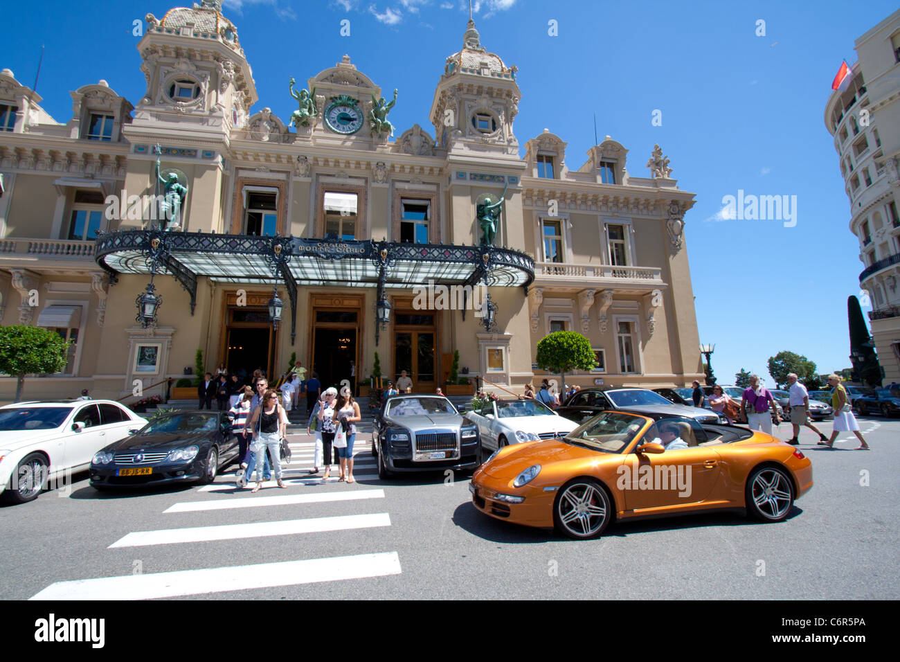 Porche sports car driving in front of a casino in Monaco Stock Photo