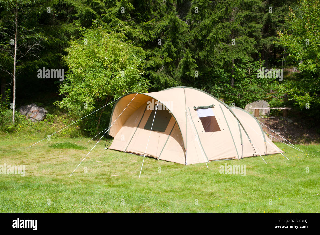 A tent on a campsite in the woods Stock Photo