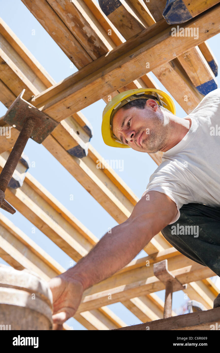 Construction worker under formwork girders Stock Photo