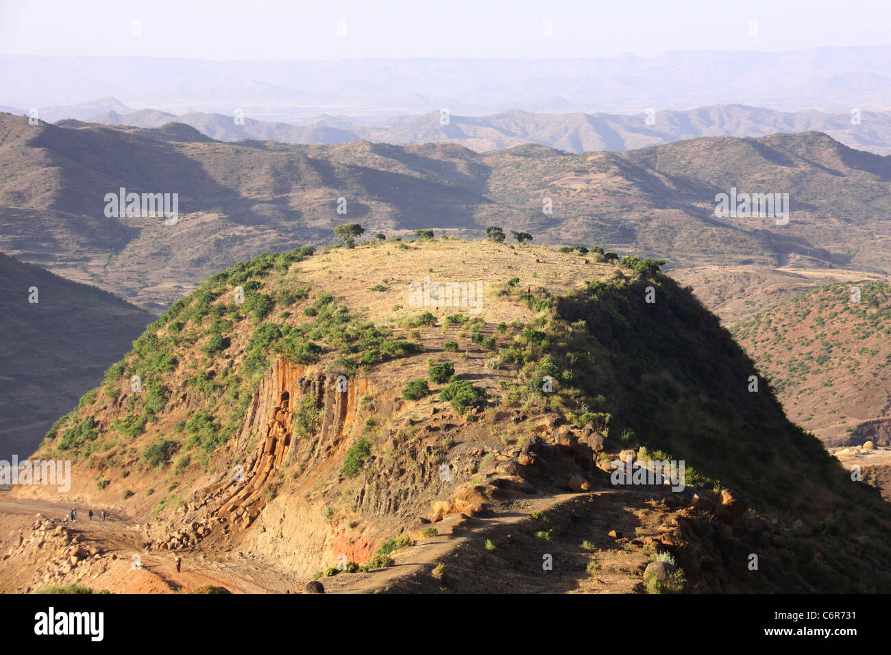 A scenic view of a mountain top with mountain ranges in the background Stock Photo