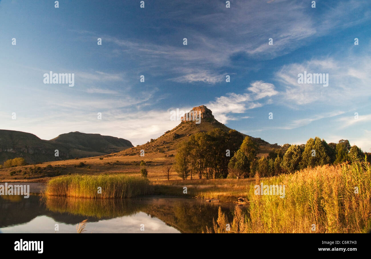 Clarens scenery showing a distant sandstone koppie with a dam in the foreground Stock Photo