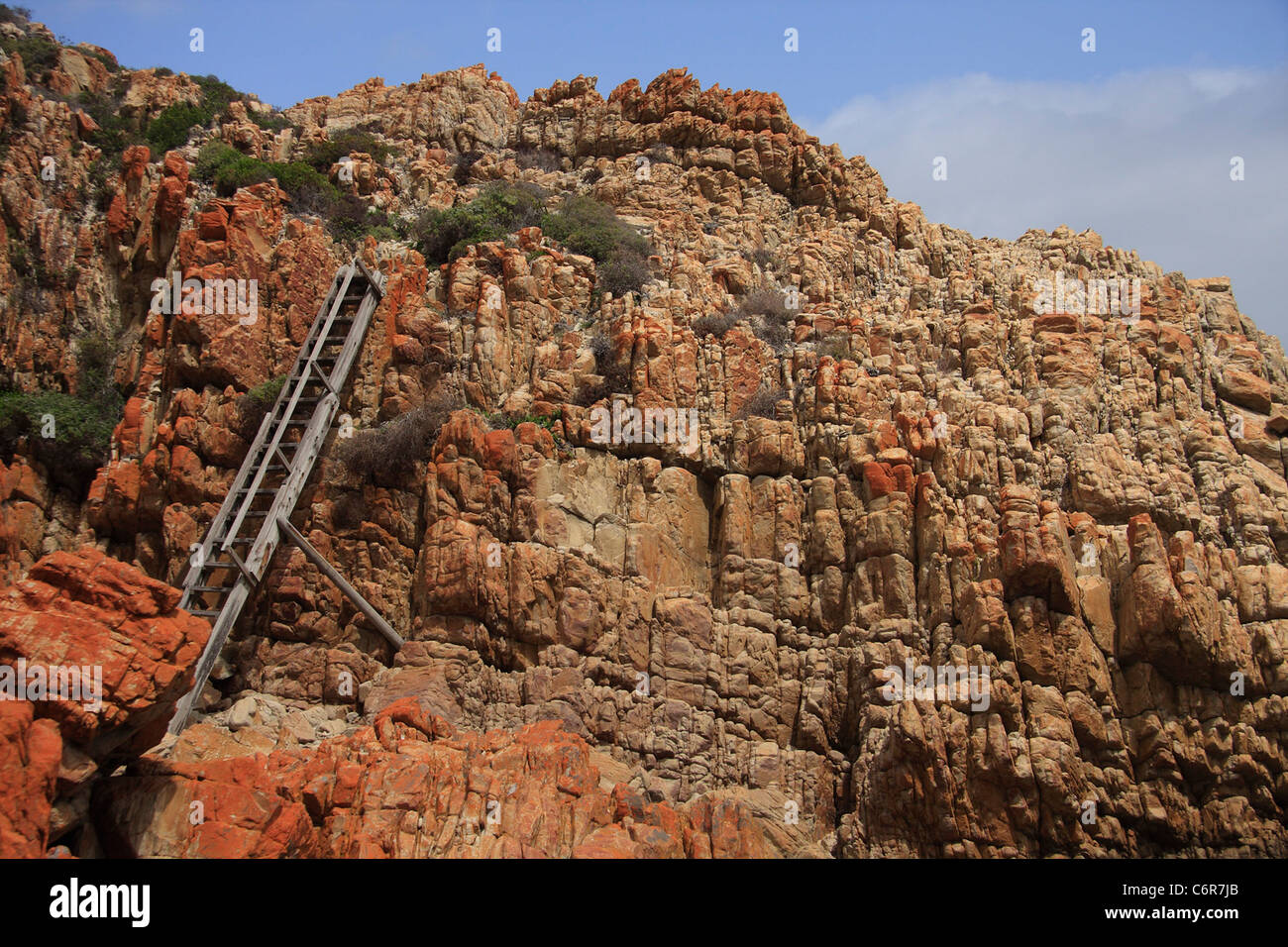 Wooden ladder going up a steep and rocky incline Stock Photo