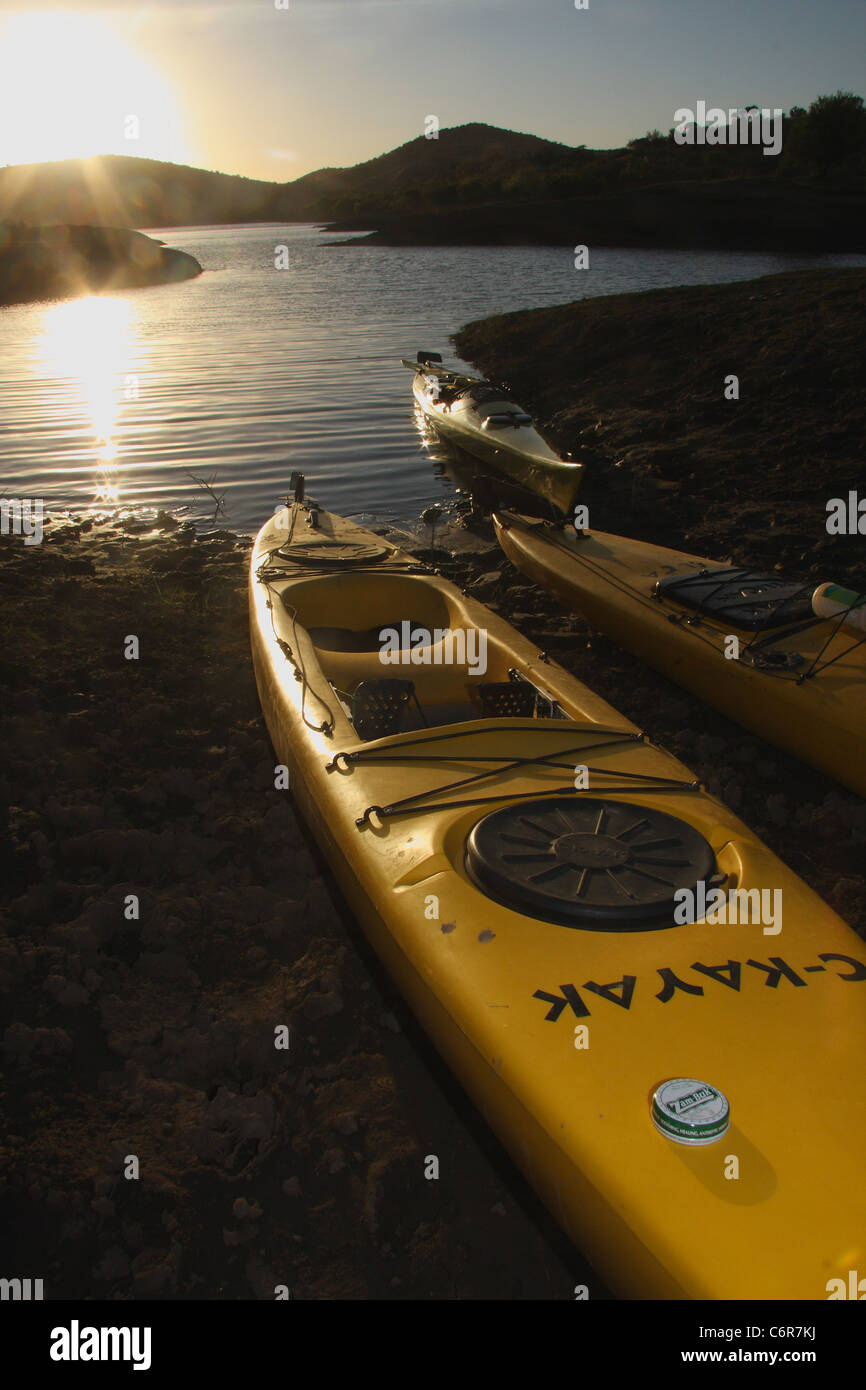 Kayaks on the banks of Van Der Kloof Dam at sunrise Stock Photo Alamy