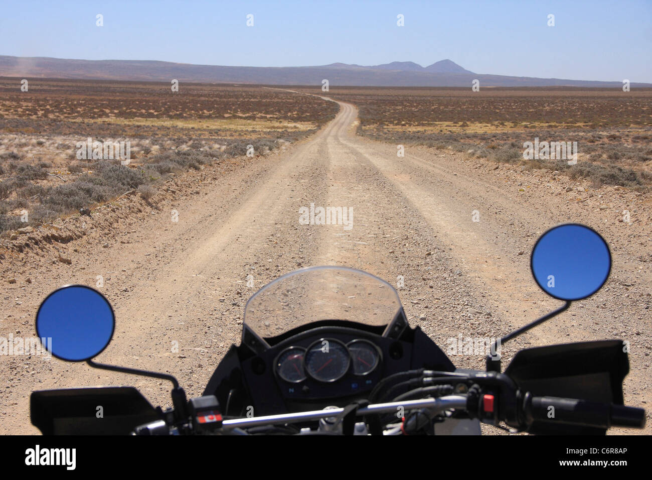 Dust road running through the Richtersveld with close-up of motorcycle Stock Photo