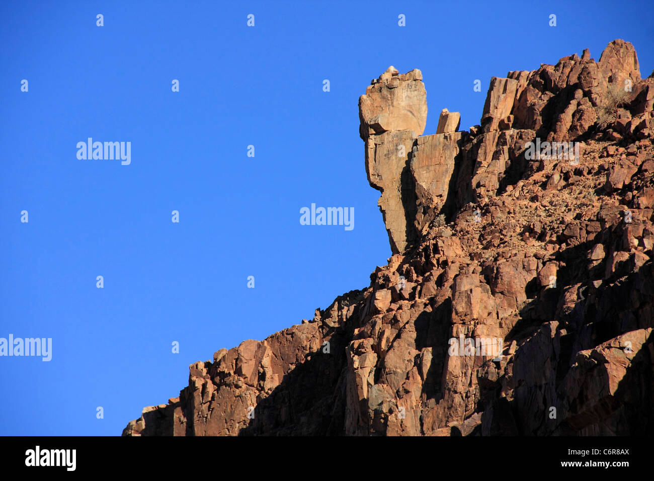 Rocky slope with face like form Stock Photo