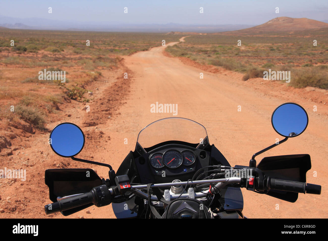 Dust road running through the Richtersveld with close-up of motorcycle Stock Photo