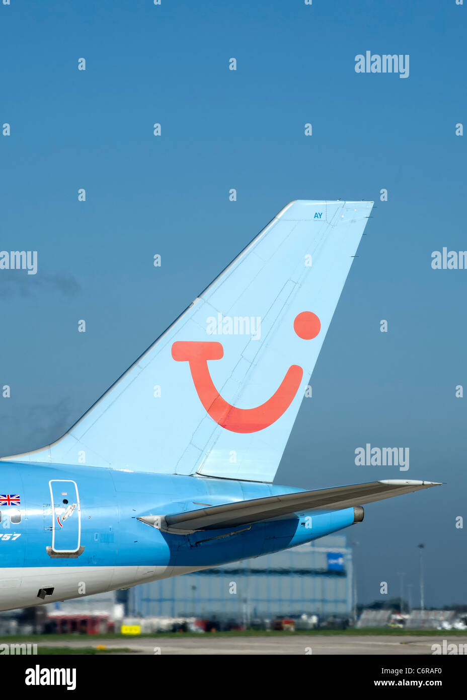Tail fin of an aircraft operated by Thomson Holidays (TUI) showing the logo Stock Photo