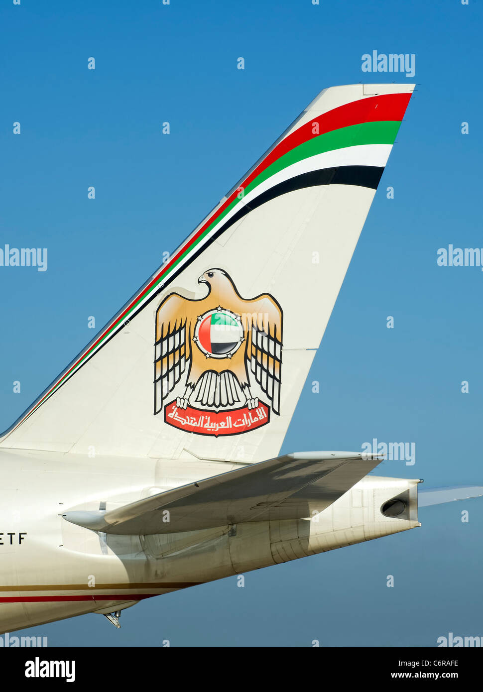 Tail fin of an Etihad aircraft showing the logo Stock Photo
