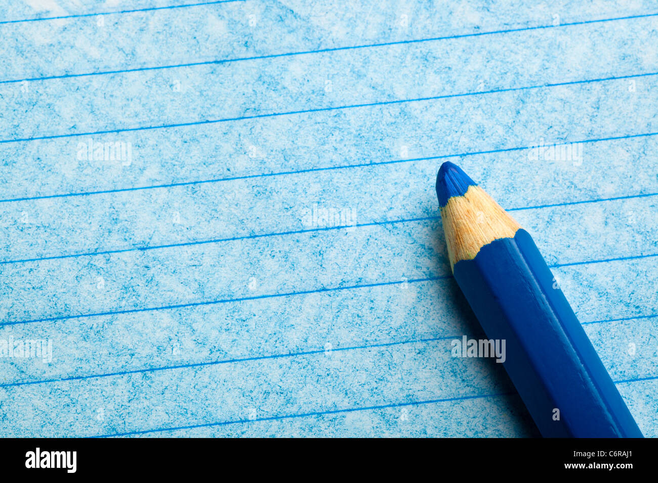 Blue color pencil with coloring on a piece of paper Stock Photo