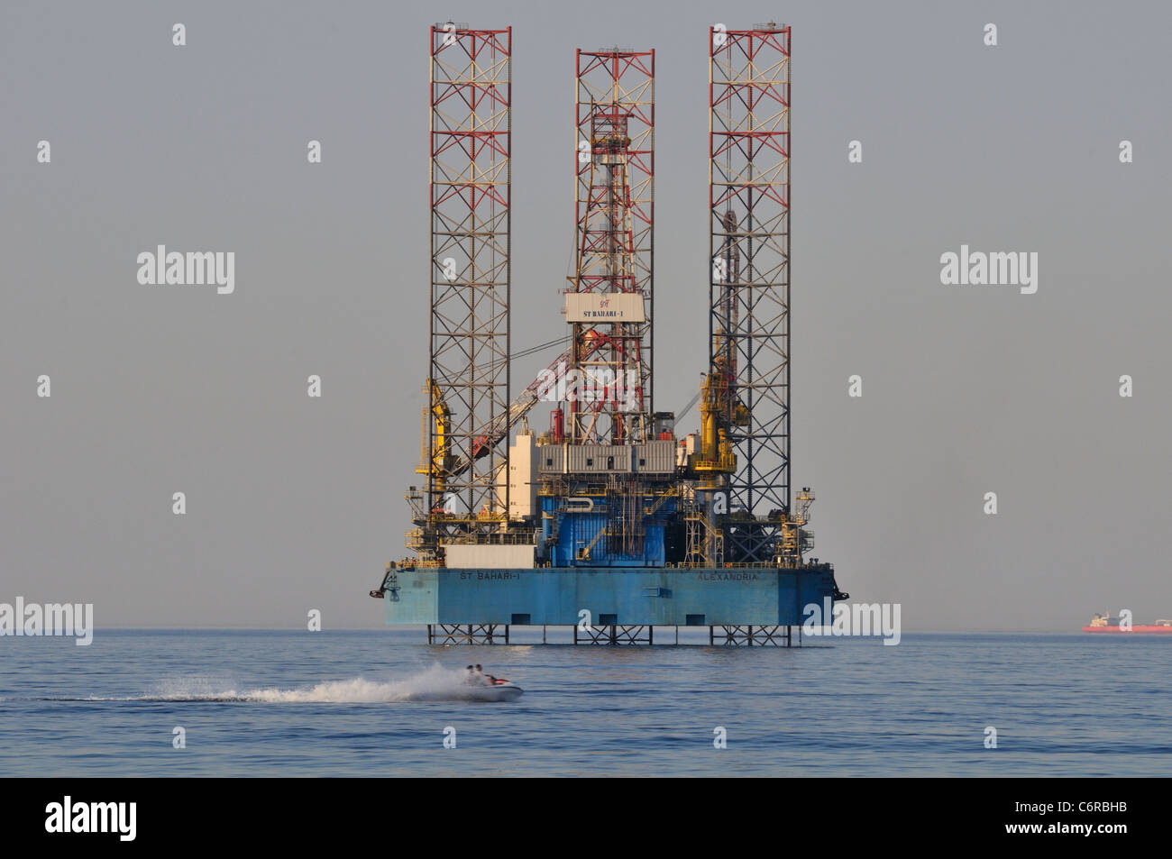 A jackup oil rig lies in the shallow waters of the Red Sea off the coast of Egypt at Ain Sokhna. Stock Photo