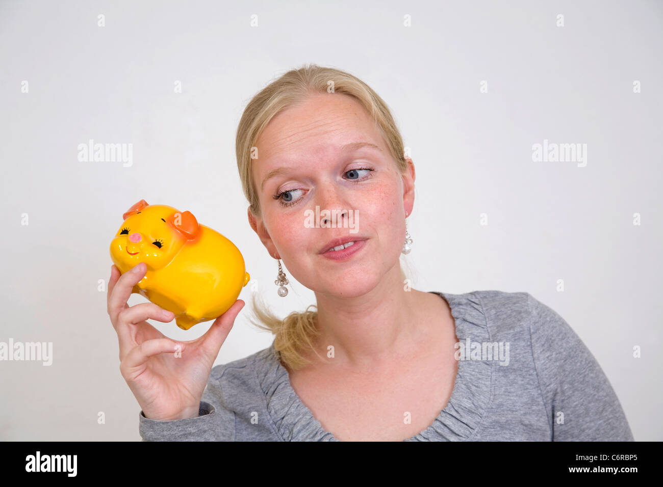 Young woman with piggy bank Stock Photo - Alamy