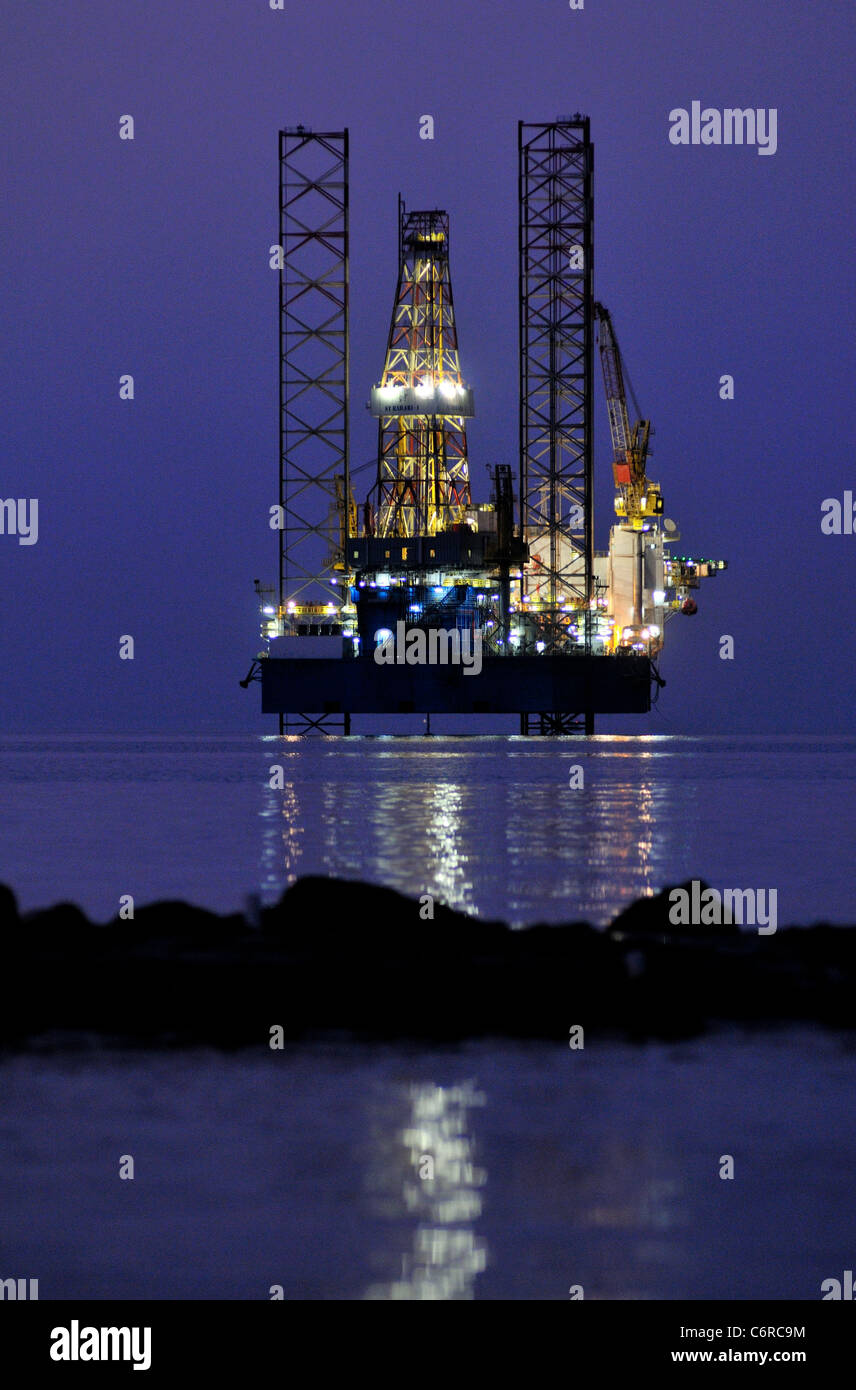 A jackup oil rig lies in the shallow waters of the Red Sea off the coast of Egypt at Ain Sokhna. Stock Photo