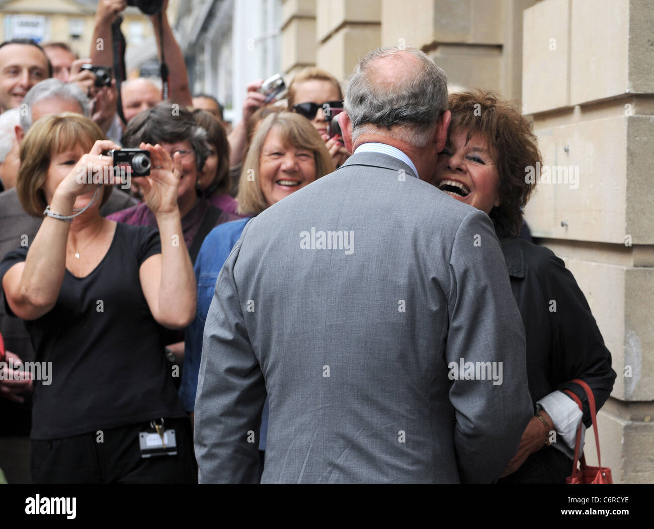 Prince Charles, Prince of Wales meets 75 year old Patricia Blair Gould, who cheekily demands a kiss, as he arrives to open the Stock Photo