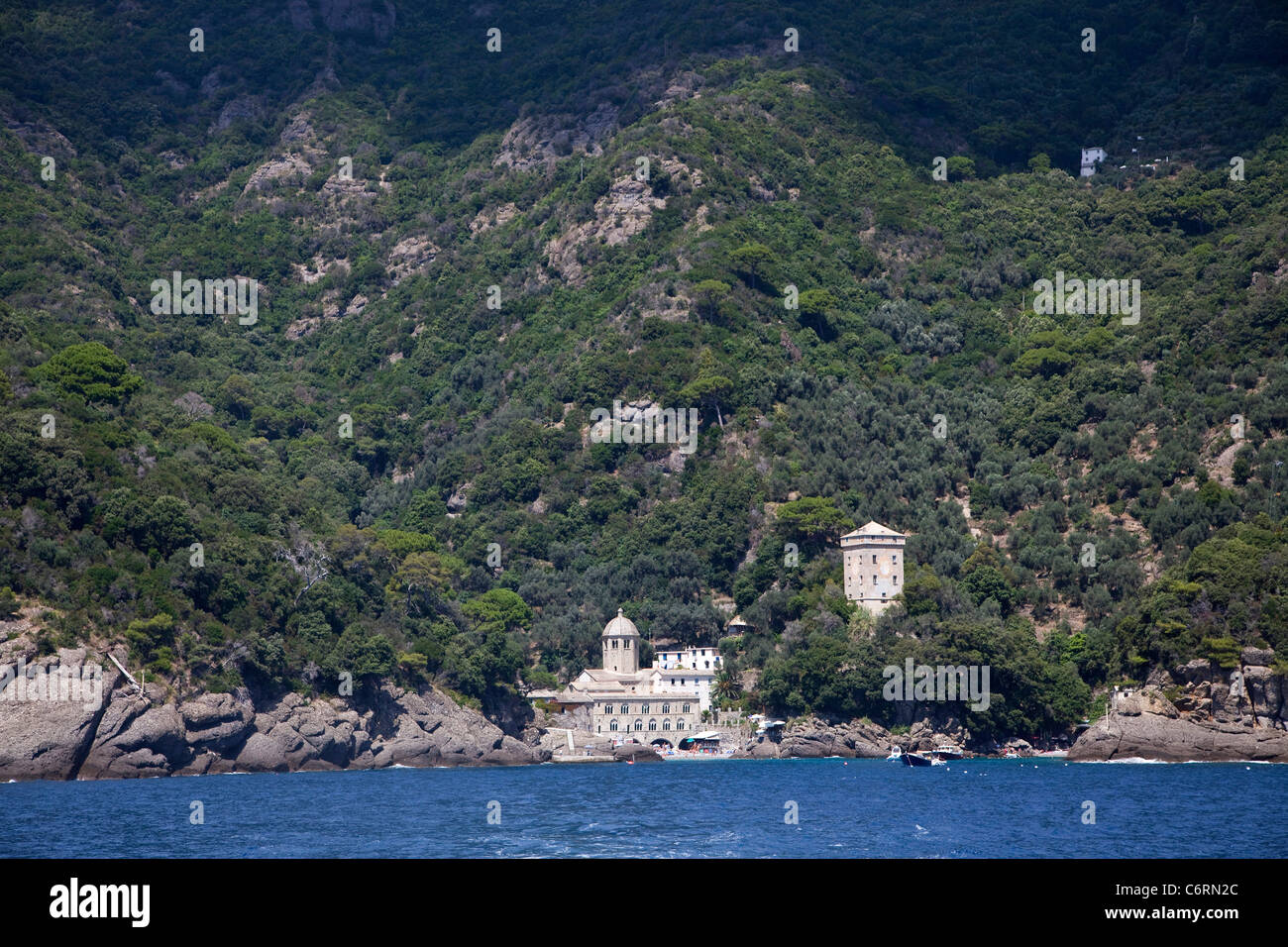 View of San Fruttuoso di Camogli, Liguria, Italy, with medieval abbey, old buildings, blue sea, beach Stock Photo