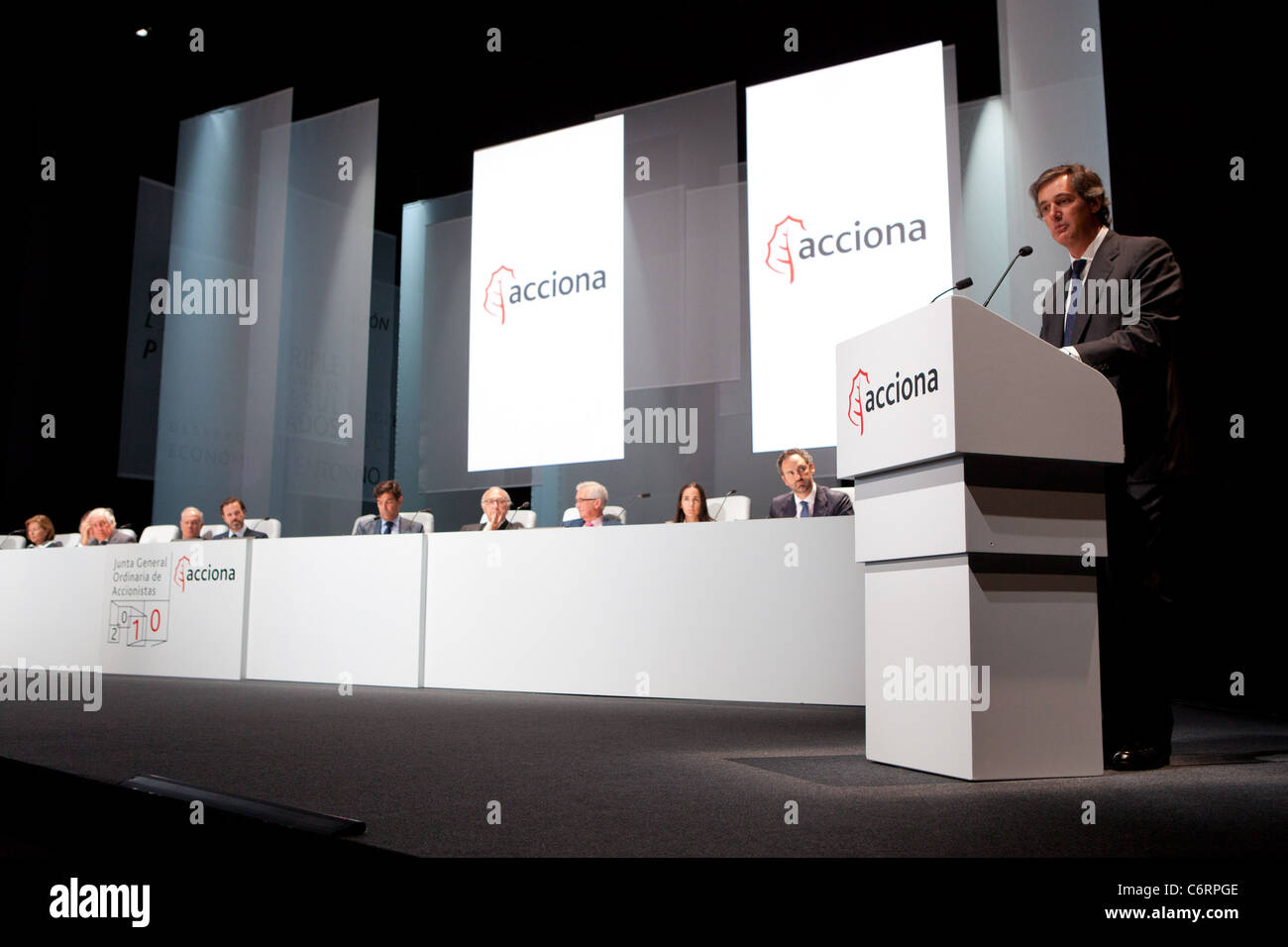 A podium speaker talks at a summit of share holders for Acciona. Miriam