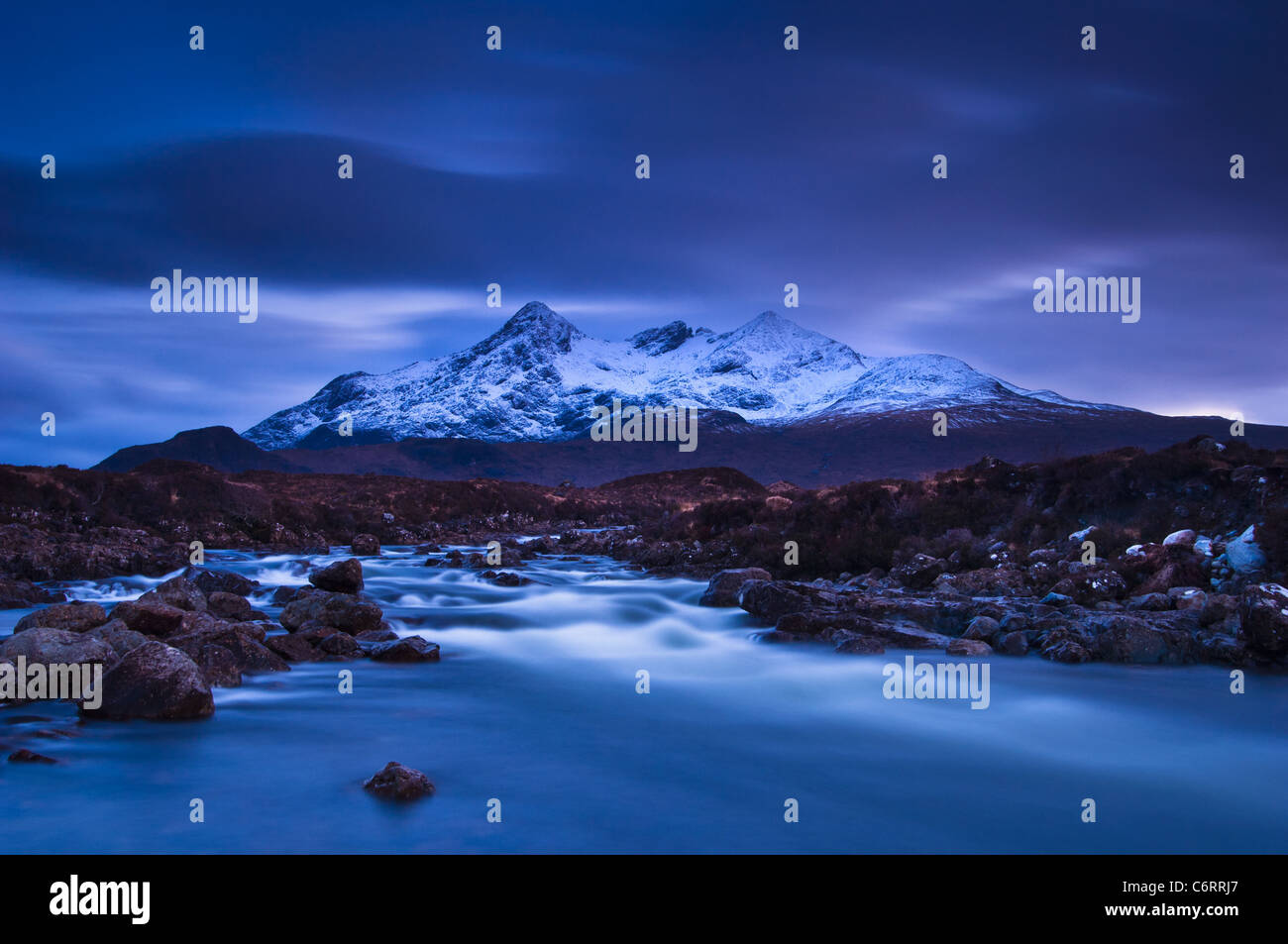 A moody twilight with aplen glow in the Cuillin Hills on the Isle of Skye, Scotland Stock Photo