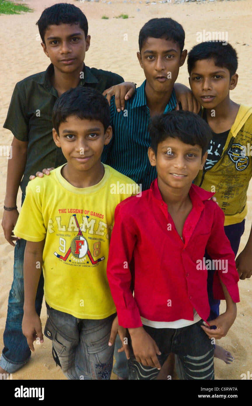 Young indian boys posing on the beack of Kollam, Kerala state, India. Stock Photo