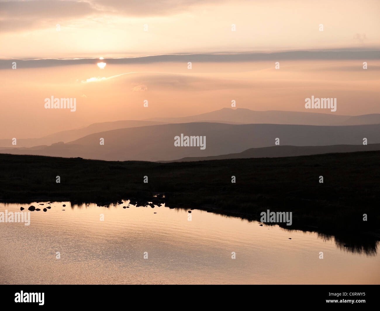 Sunrise over Peny Fan and the Central Beacons from the shores of Llyn y Fan Fawr in the Black Mountain area of Brecon Beacons Stock Photo