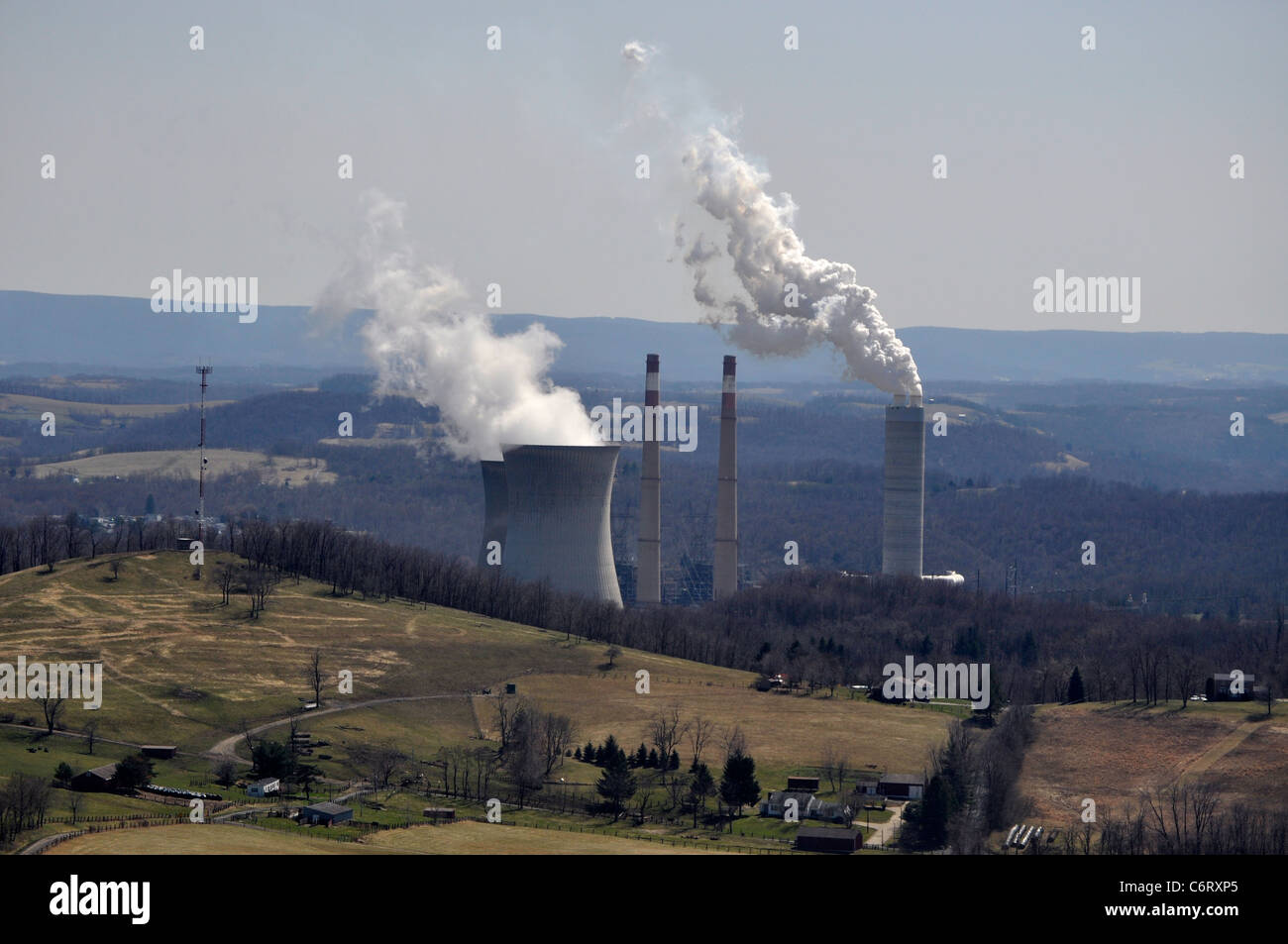 Electric power plant from an ariel view of the smoke stacks and cooling towers Stock Photo