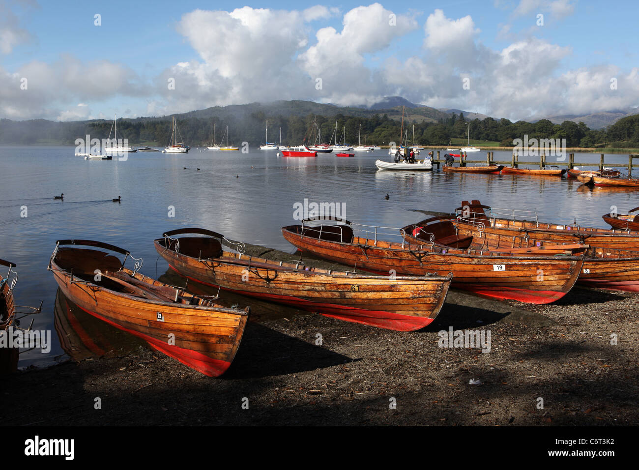 [Rowing boats] and [sailing yachts] in morning sun on [Lake Windermere] at Bowness-on-Windermere in the English [Lake District] Stock Photo