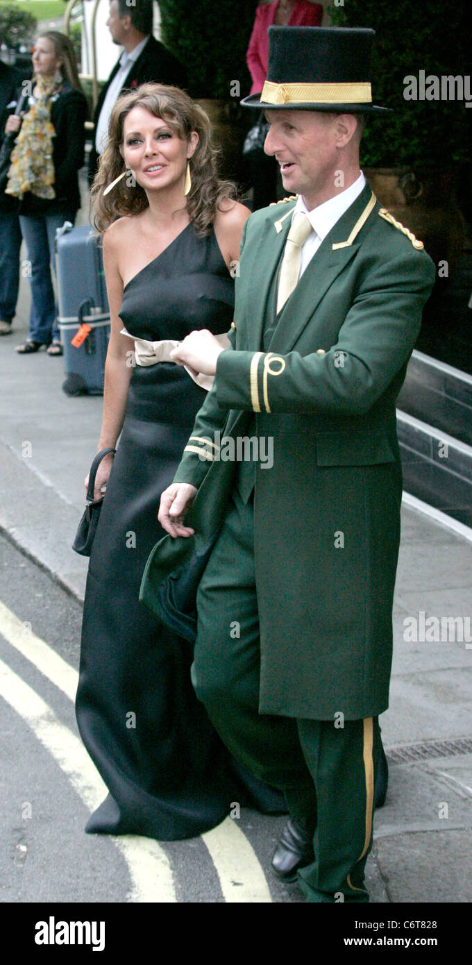 Carol Vorderman wearing a full length dress as she leaves the Dorchester  showing some unique folds in her seams that accentuate Stock Photo - Alamy