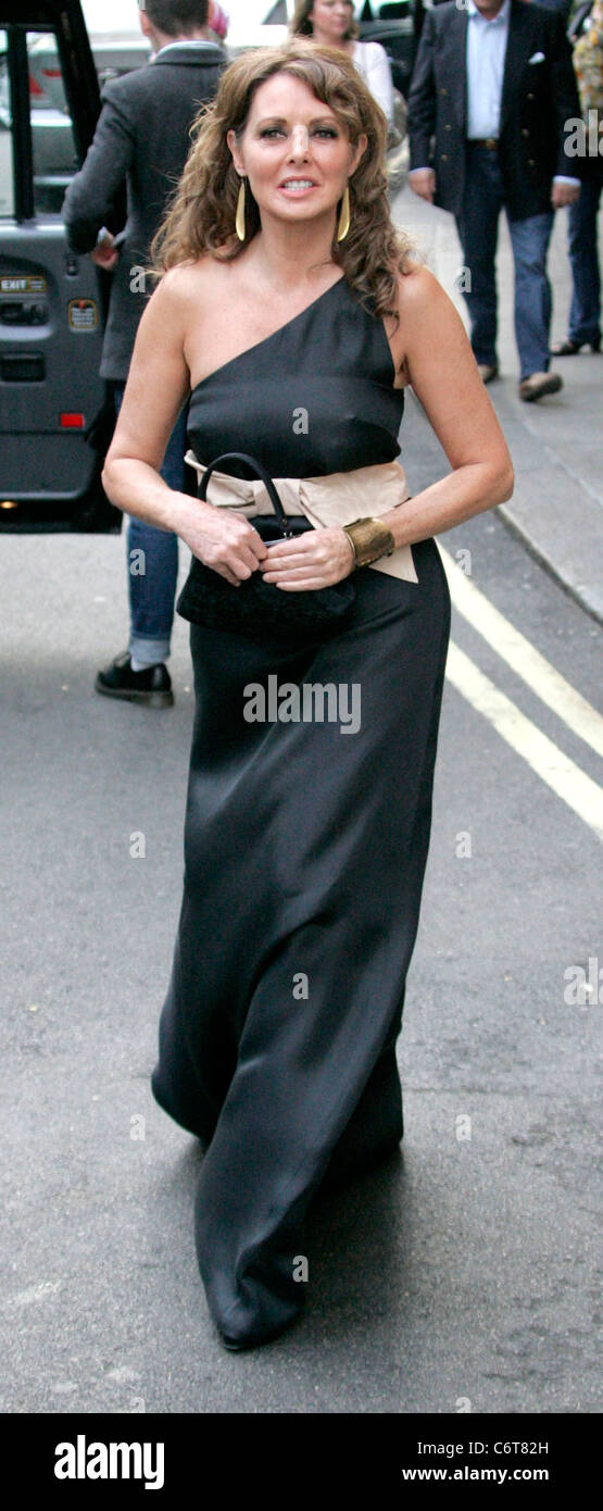 Carol Vorderman wearing a full length dress as she leaves the Dorchester  showing some unique folds in her seams that accentuate Stock Photo - Alamy