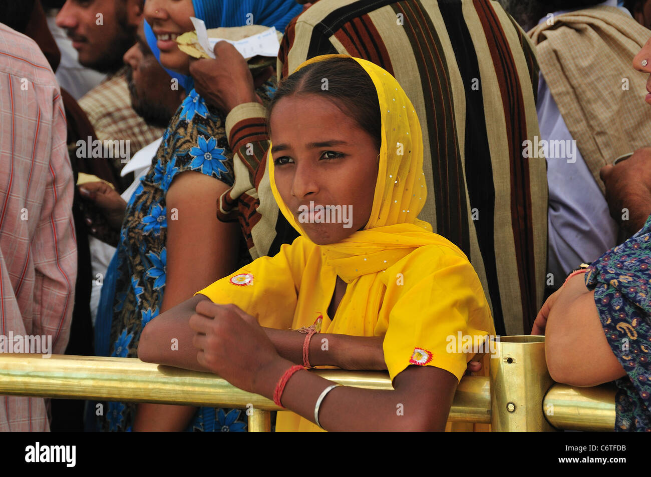 Pilgrim girl on the queue go inside to the holly Golden Temple. Stock Photo