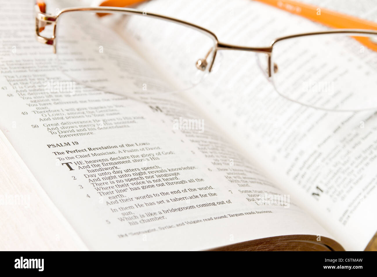 Holy Bible opened with glasses on it Stock Photo