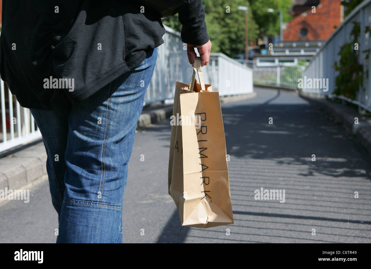 girl walking with primark shopping bag Stock Photo