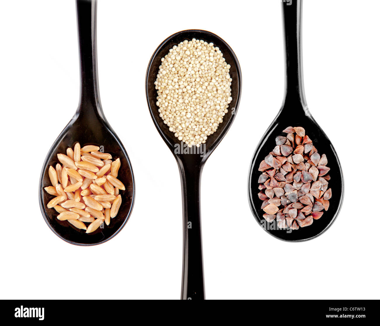 Black japanese style spoons of Kamut wheat,Quinoia, buckwheat, grains Stock Photo