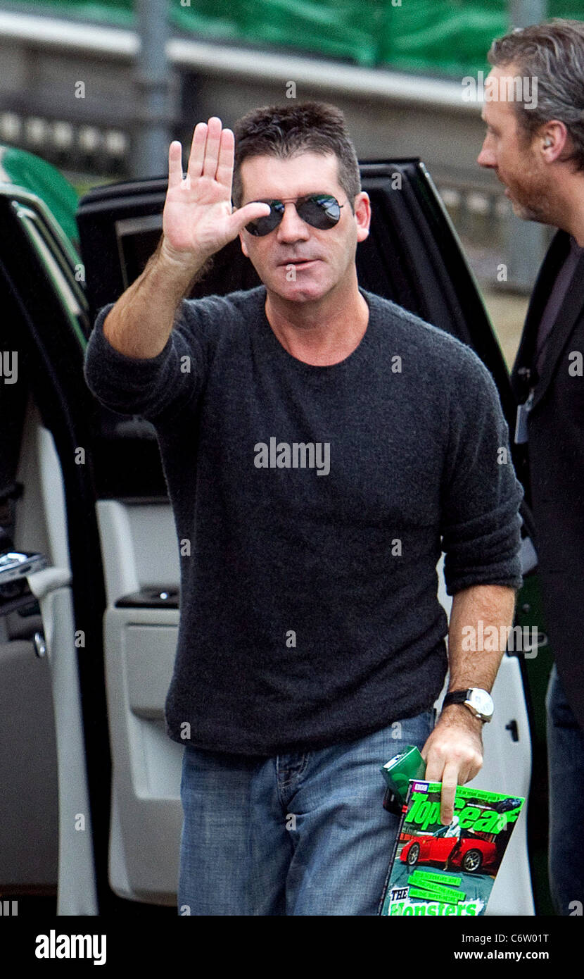 Simon Cowell carrying a 'Top Gear' magazine The 'Britain's Got Talent' judges arriving at the television studios ahead of the Stock - Alamy