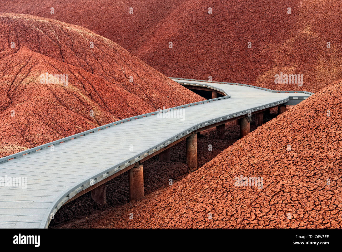 A boardwalk leads through the ash deposits along the Painted Cove Trail in Oregon’s John Day Fossil Beds National Monument. Stock Photo