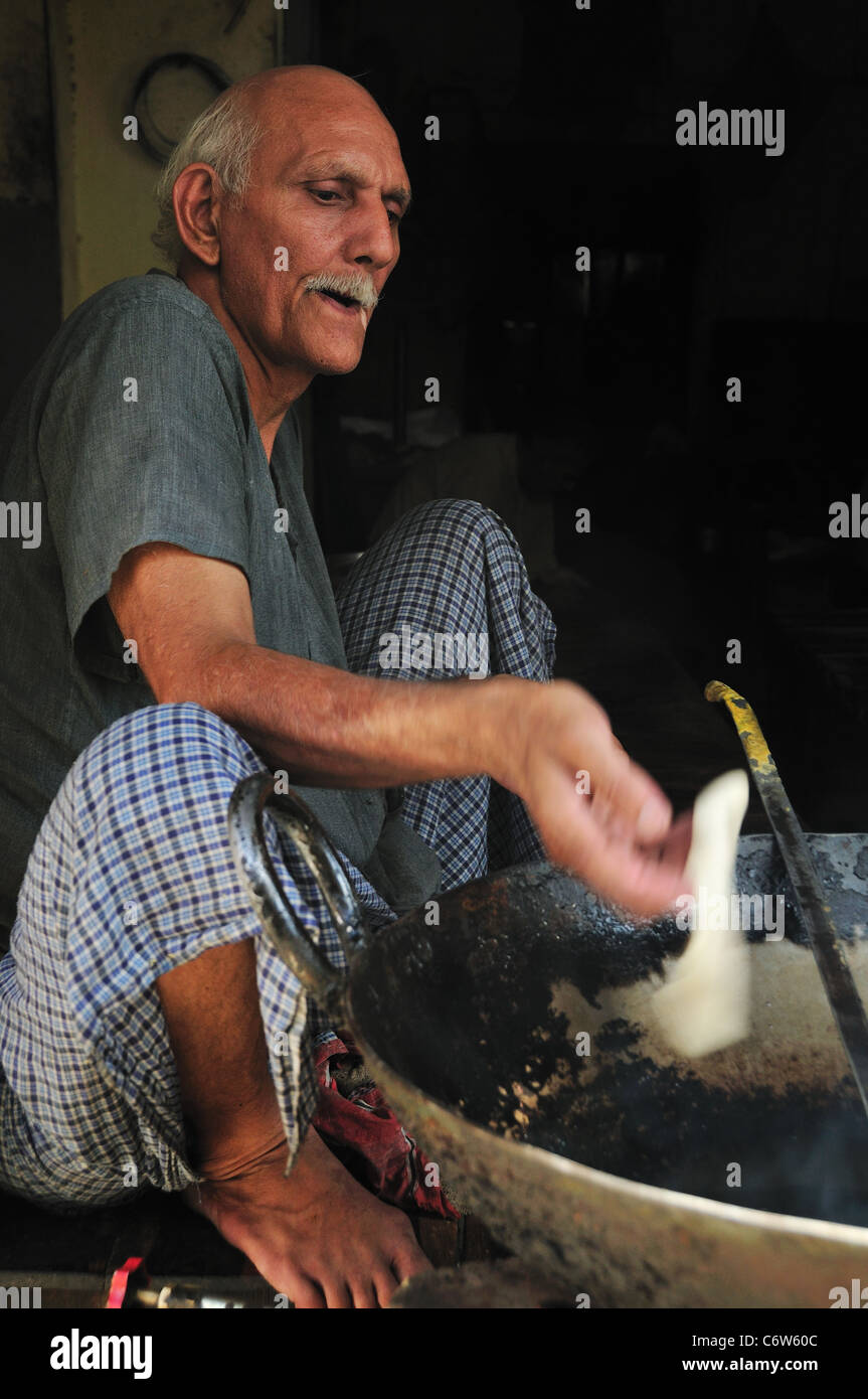 The man making Puri at the local restaurant. Stock Photo