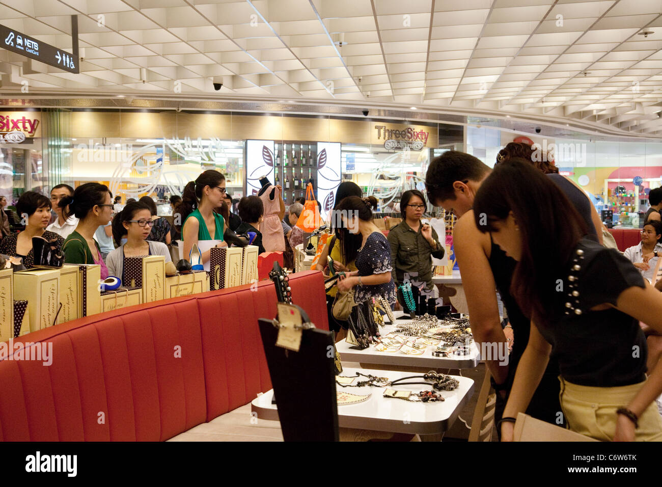 Shoppers in the busy Ion shopping mall, Orchard Road, Singapore asia Stock Photo
