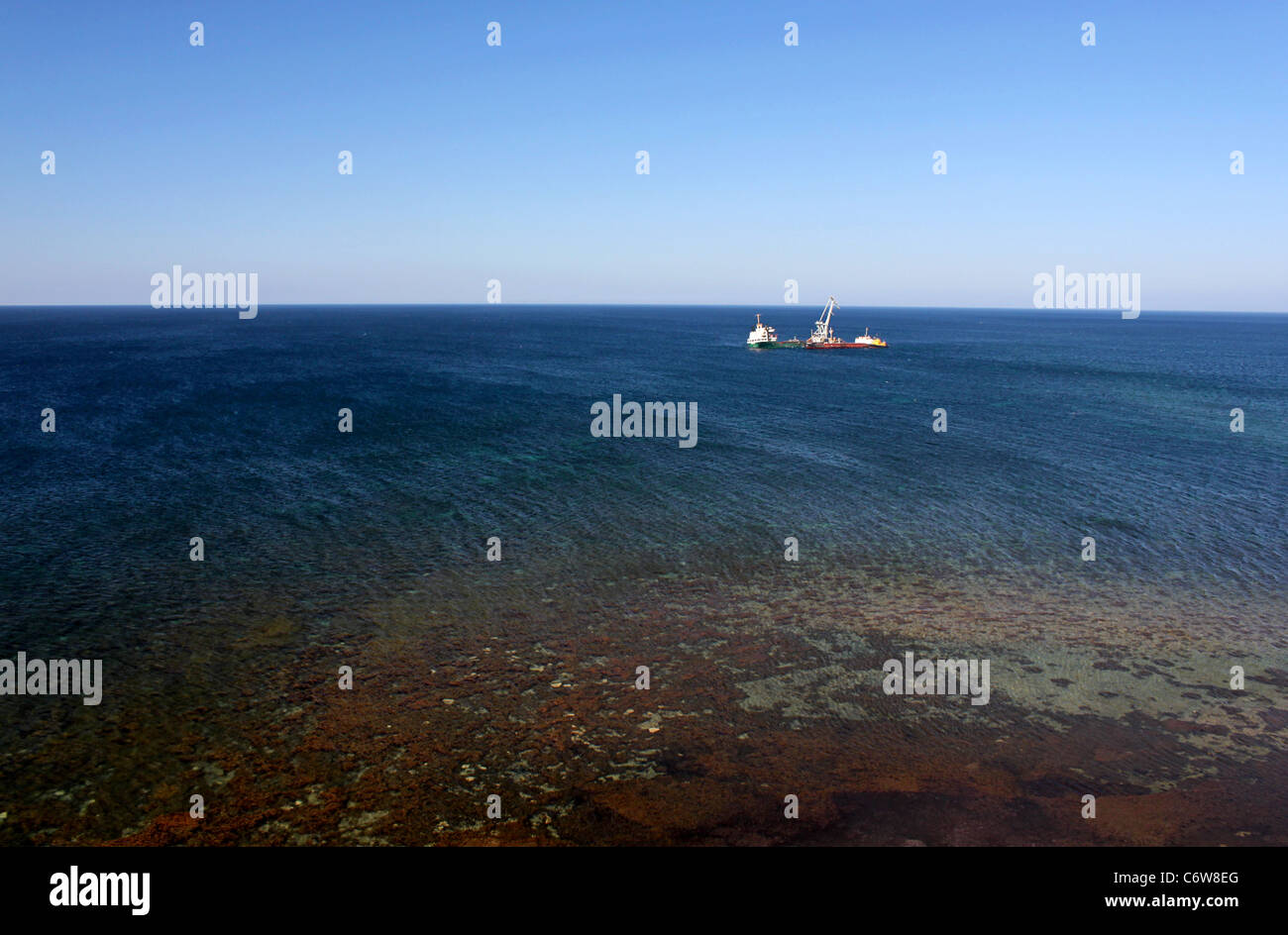 view on sea with ship run aground Stock Photo