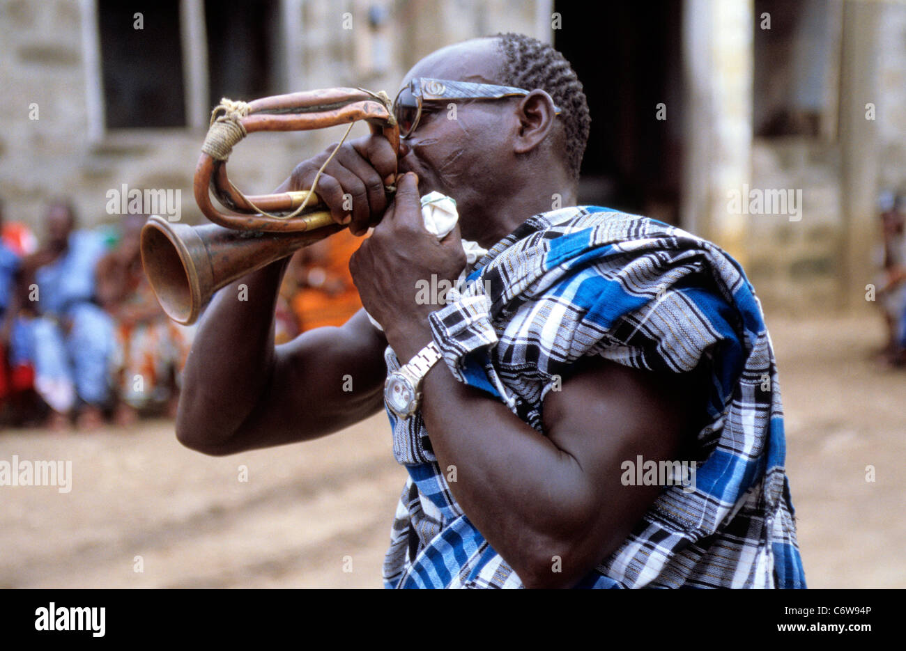 Professional Mourner plays a horn at the funeral of an elder Kokrobite, near Accra, Ghana. Stock Photo