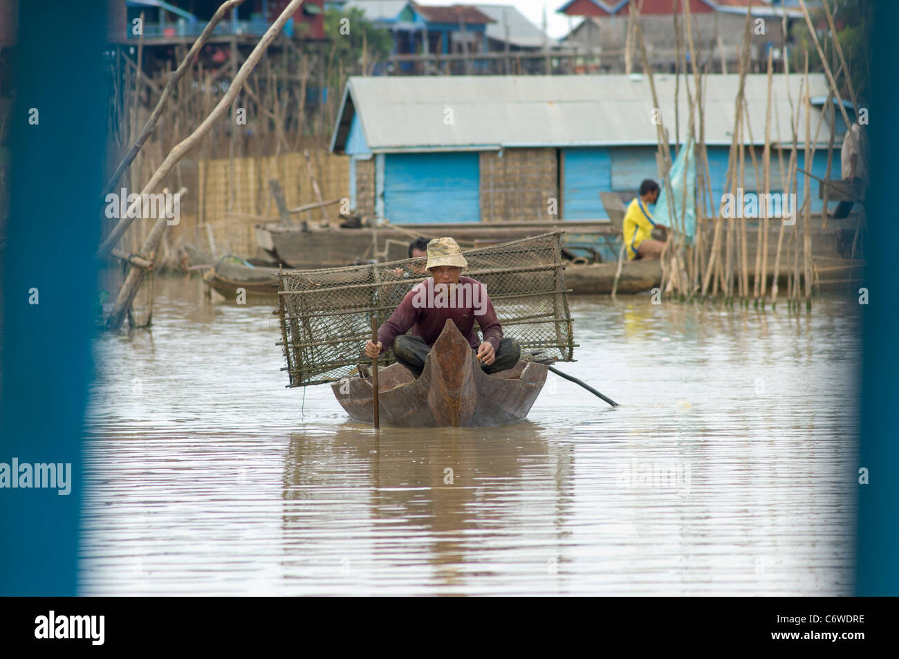 Fishing boat with fishing baskets in a tributary of Tonle Sap lake, at Kompong Klang village near Siem Reap, Cambodia Stock Photo
