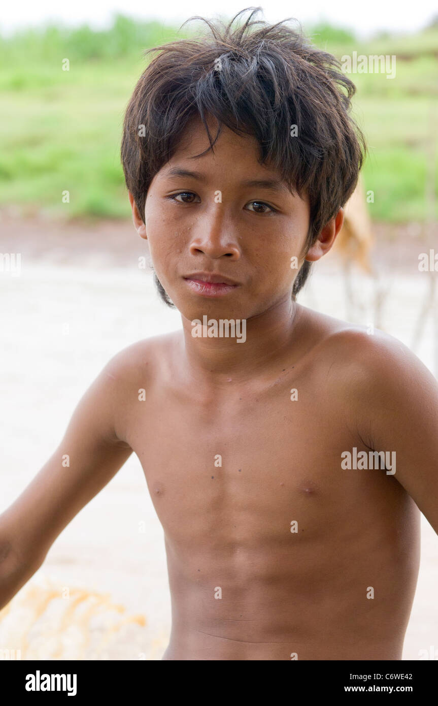 Boy working on a tourist boat, Tonle Sap lake, near Siem Reap, Cambodia ...