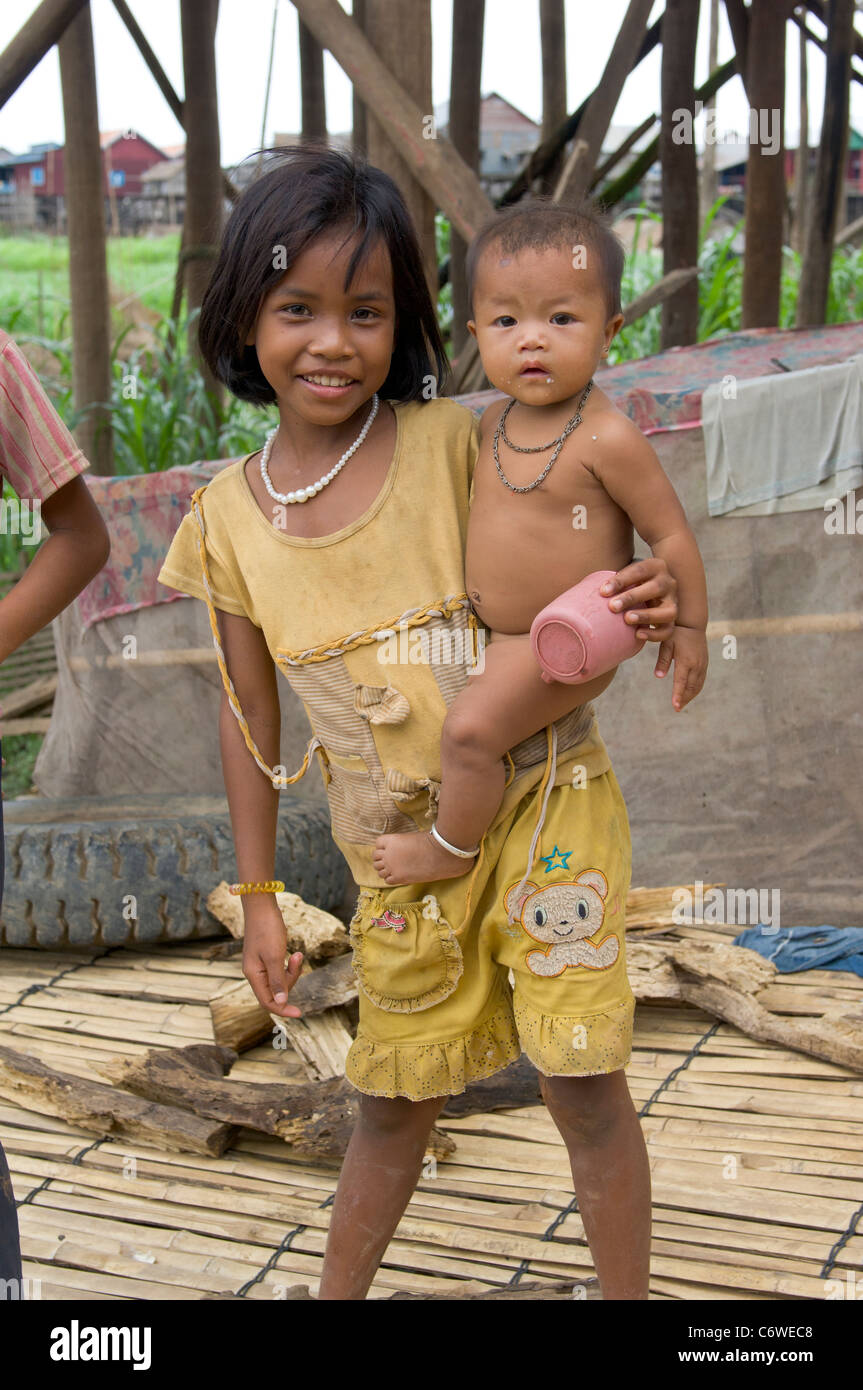 Naked girls babys Young Girl Holding A Naked Baby On Her Hip Kompong Klang Village Near Siem Reap Cambodia Stock Photo Alamy
