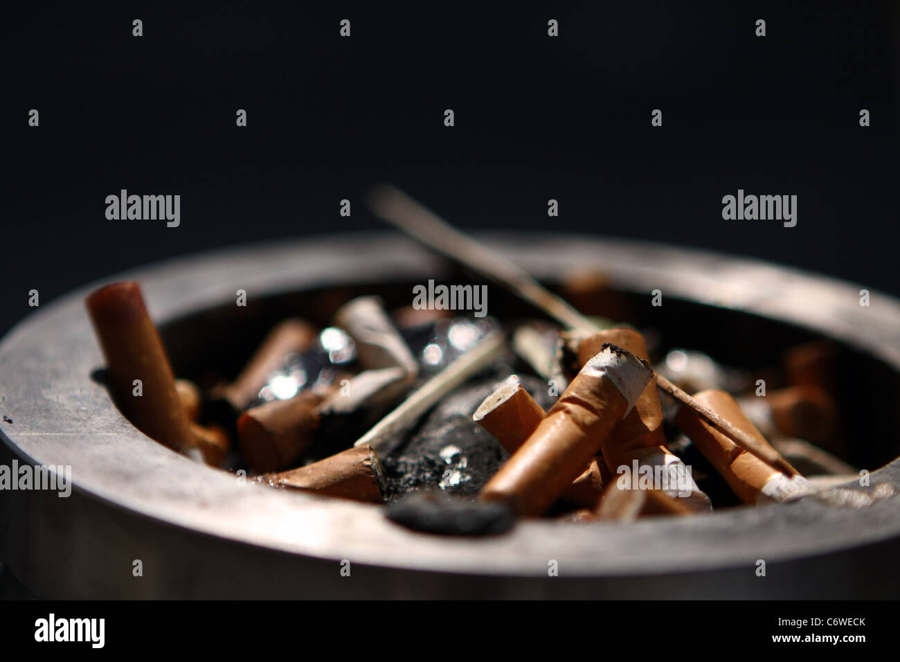 Cigarette butts in a public ashtray in a street in London Stock Photo