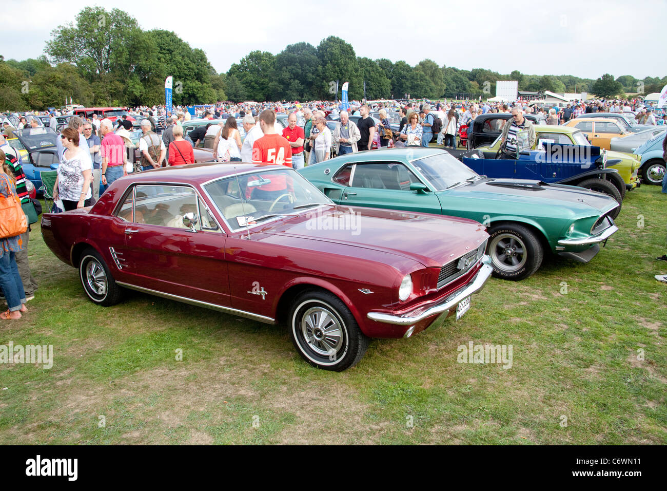 Classics on the Common Harpenden 2011 USA Ford Mustang classic car red 1966 green Mach 1 1969 Cobra jet 428 muscle motor show Stock Photo
