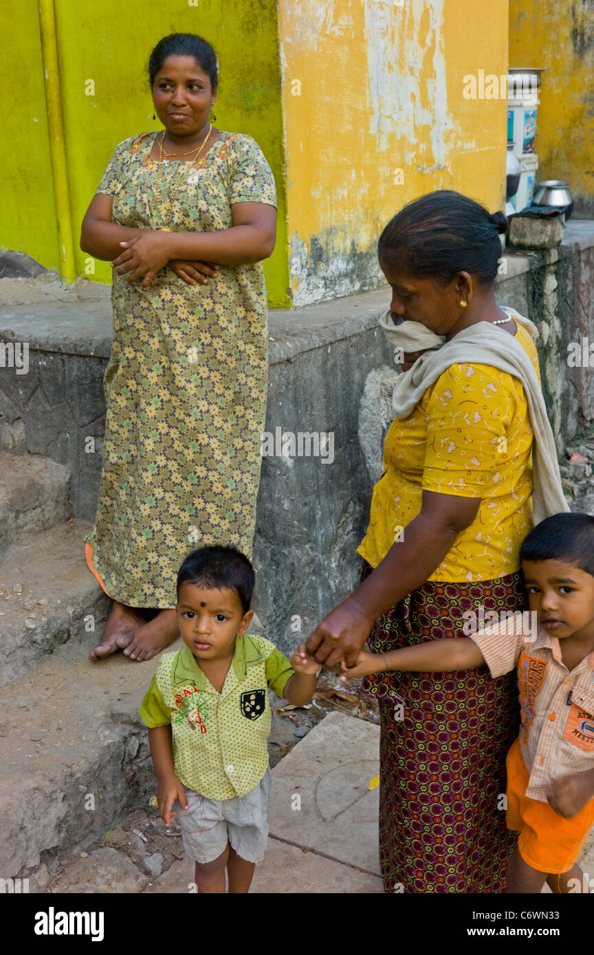 Indian families relaxing in front of their homes in Kollam, Kerala. Stock Photo