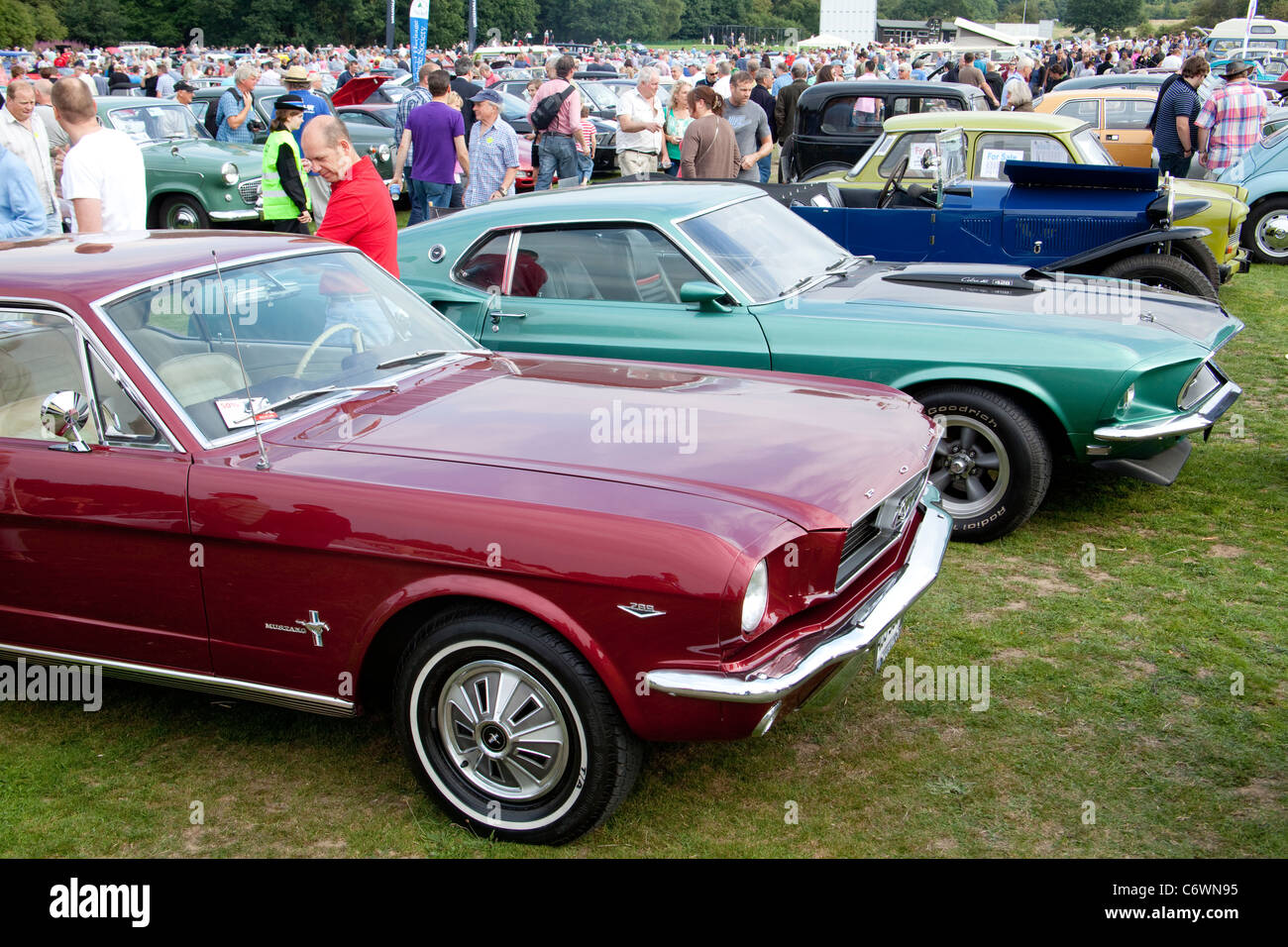 Classics on the Common Harpenden 2011 USA Ford Mustang classic car red 1966 green Mach 1 1969 Cobra jet 428 muscle motor show Stock Photo