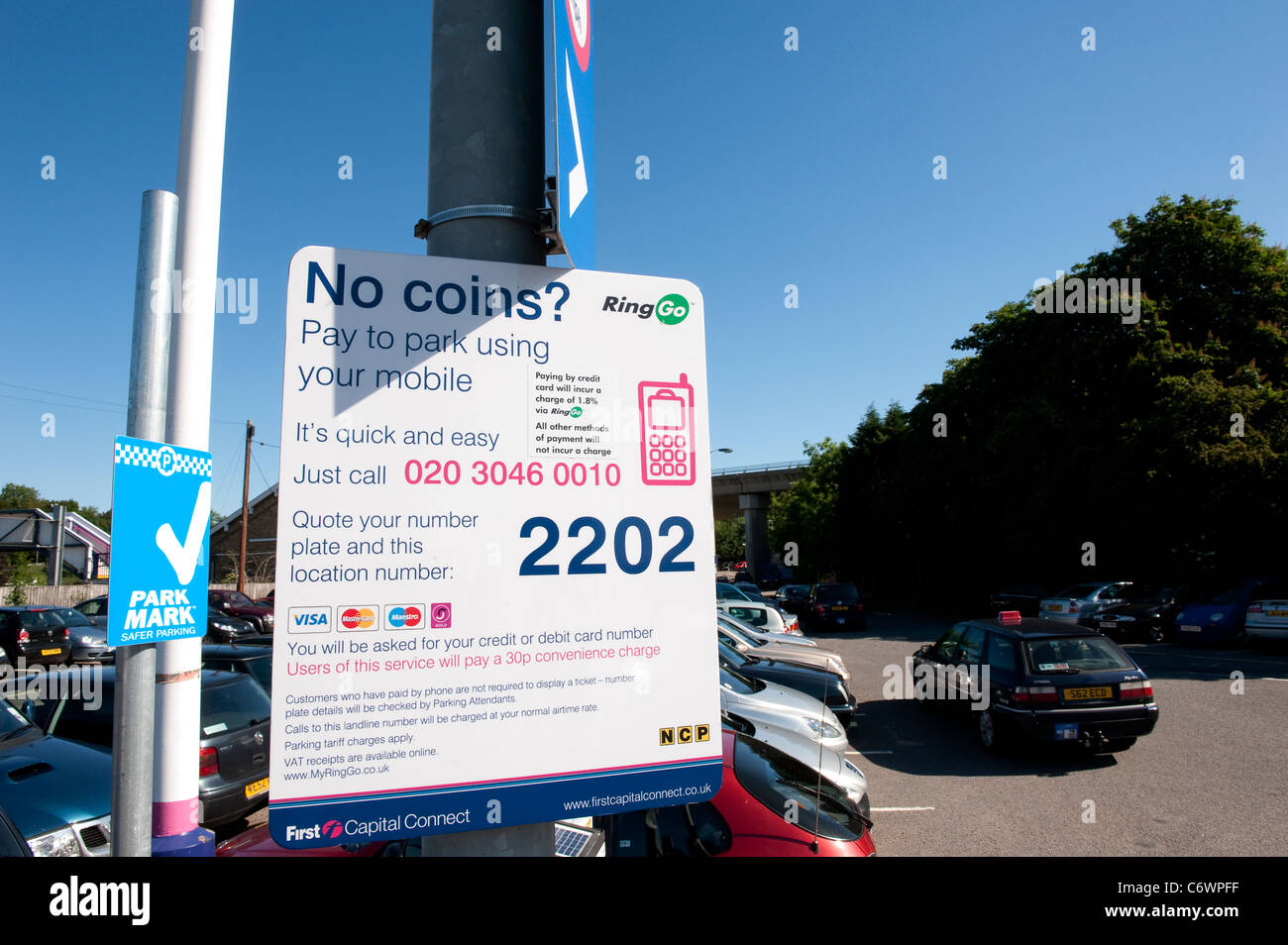 Sign in a busy railway station car park inviting visitors to pay for