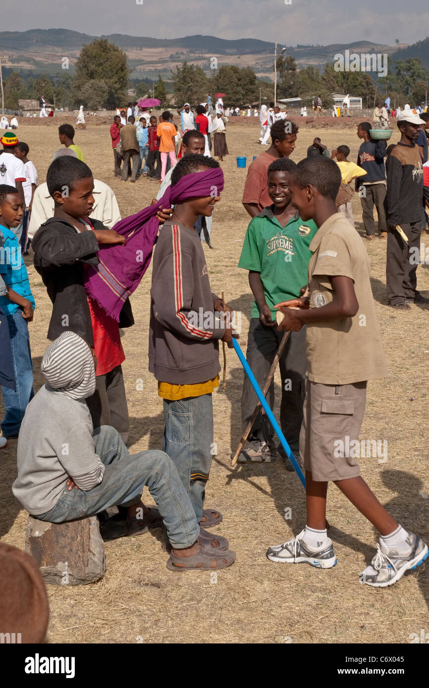 Young being blindfolded in preparation for a traditional Ethiopian