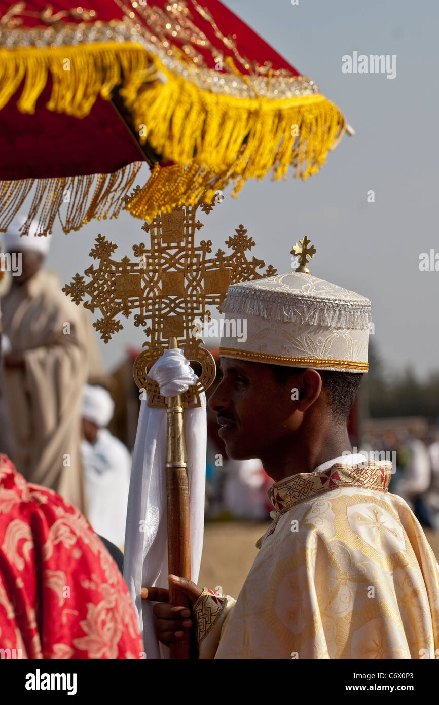 Christian Orthodox devotees holding the Lalibela Cross at the Timket Festival. The Timkat (Amharic "baptism") (also spelled Timk Stock Photo